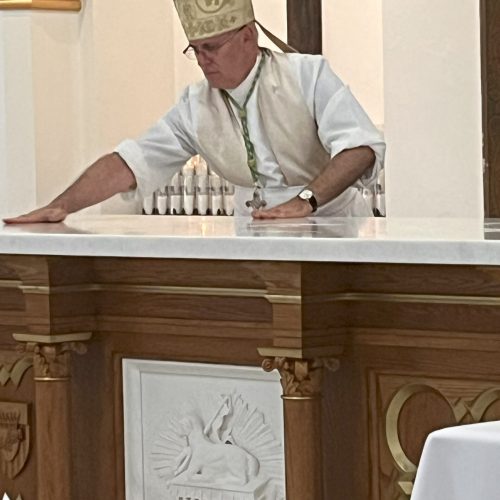 Bishop Rhoades consecrating the new altar