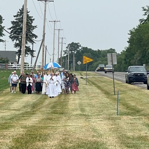 Parishioners of Saint Gaspar walking along highway 9 in a Eucharistic procession